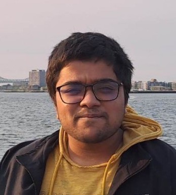 Portrait photo of Bhavya Agarwalla in front of water with a city in the distance